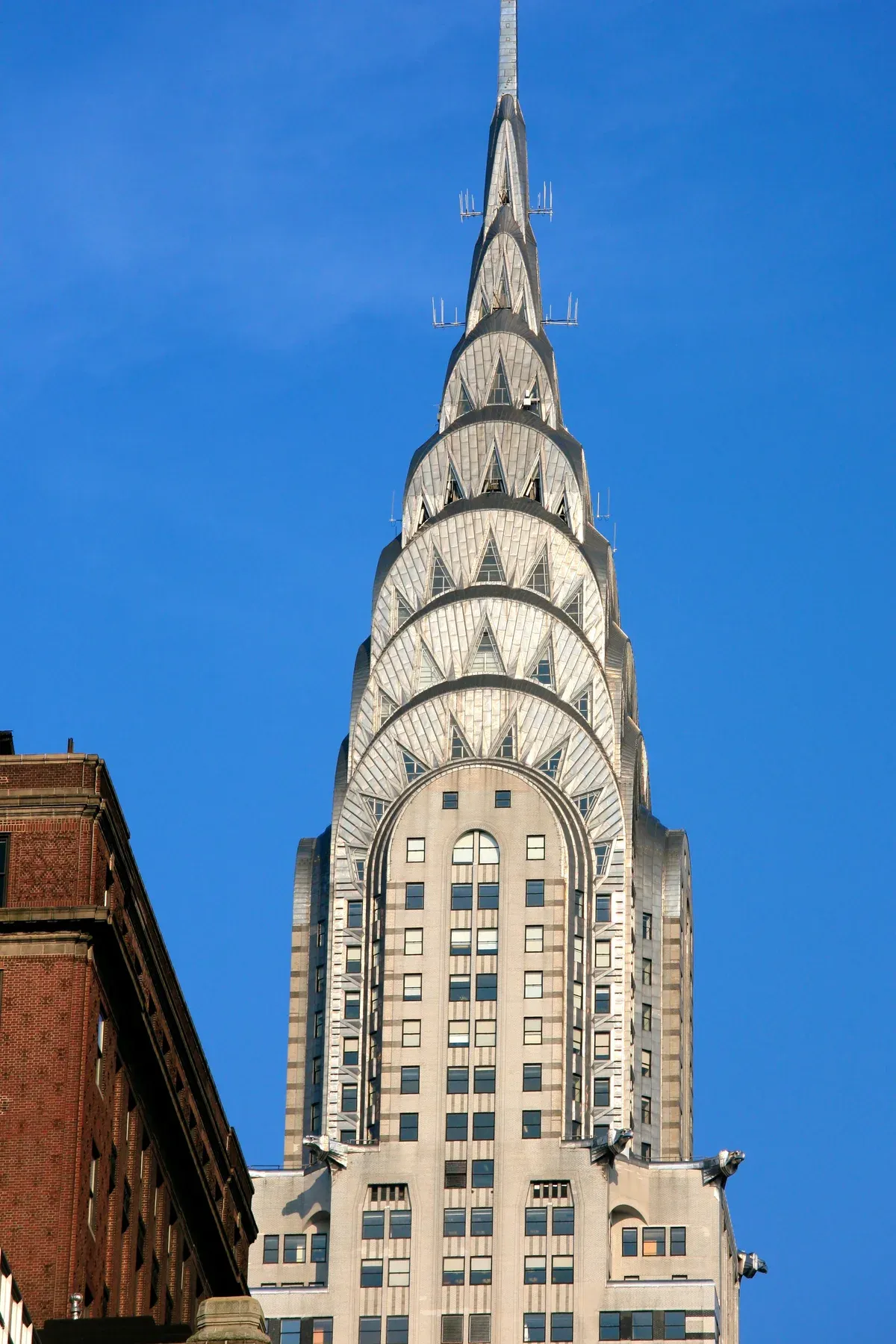 The stainless-steel crown of the Chrysler Building against a clear blue sky, on a New York architecture tour