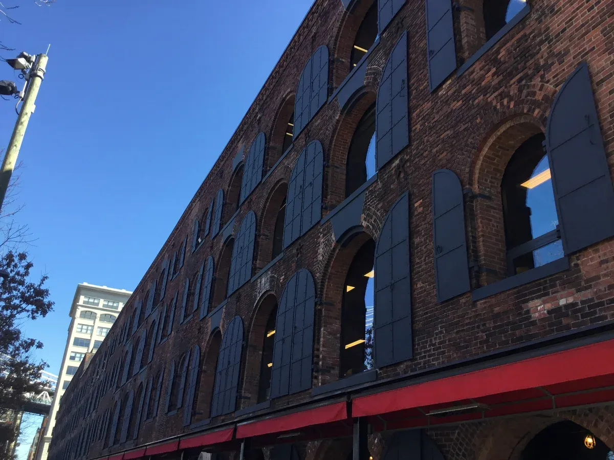 The brick arched warehouse walls of Empire Stores in DUMBO, Brooklyn, on a New York architecture tour