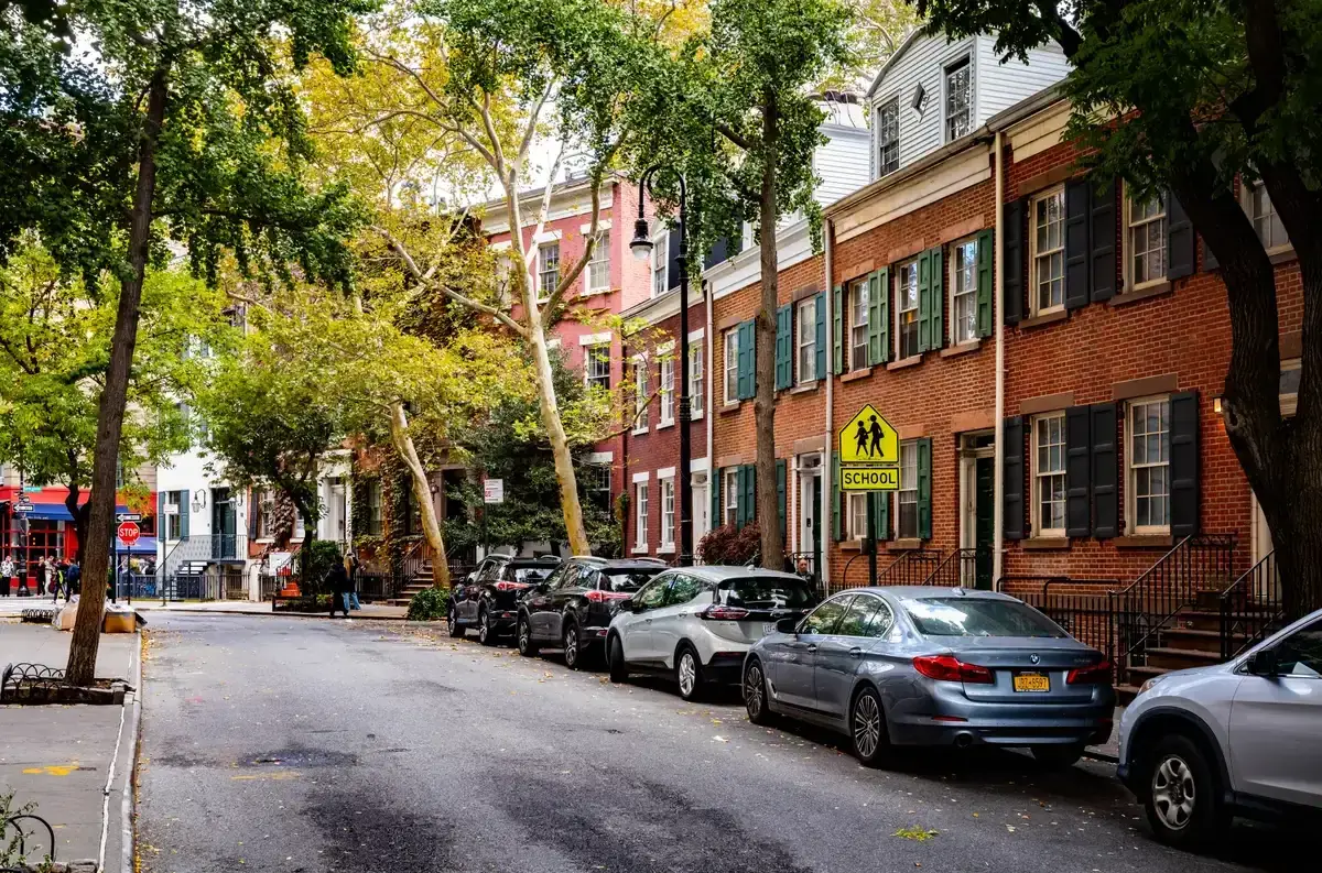 Brick rowhouses with green shutters along Grove Street in Greenwich Village, on a New York architecture tour