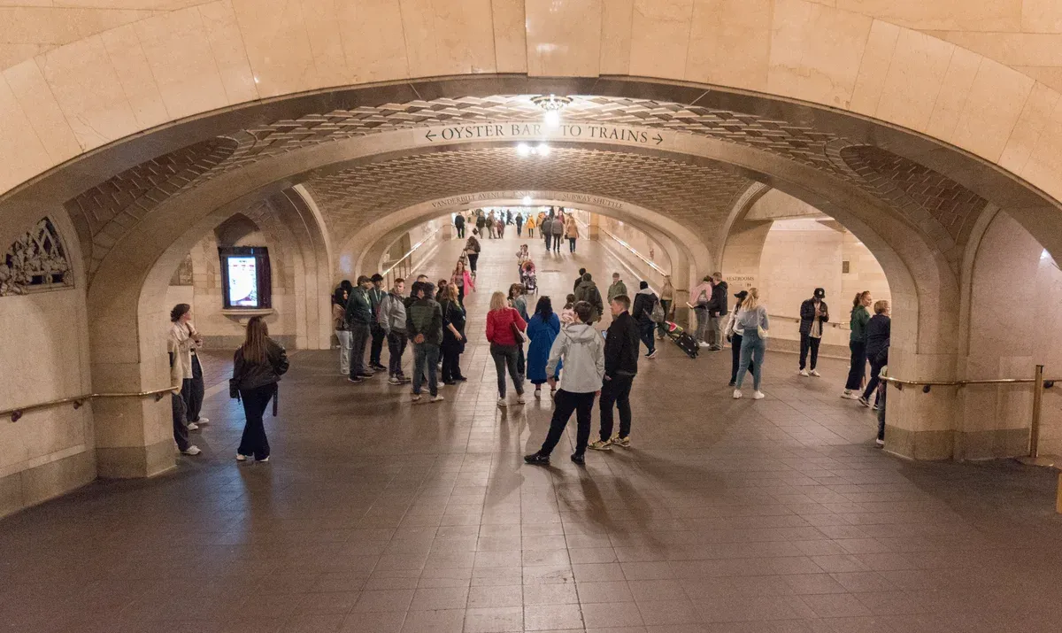 People walking through the tiled vaults of the Whispering Gallery in Grand Central Terminal, on a New York architecture tour