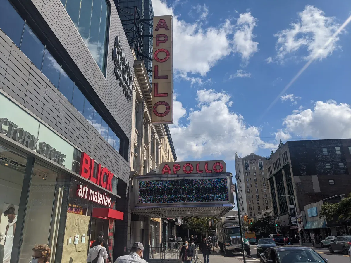 The vertical Apollo sign and marquee of the Apollo Theater on 125th Street in Harlem, on a New York architecture tour