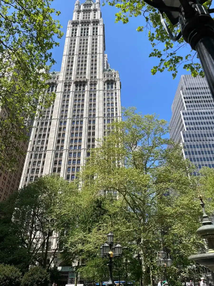 The Woolworth Building tower seen through the trees of City Hall Park, on a New York architecture tour
