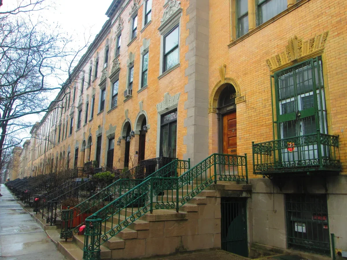 The yellow-brick rowhouses and green iron stoops of Strivers' Row in Harlem, part of a New York architecture tour